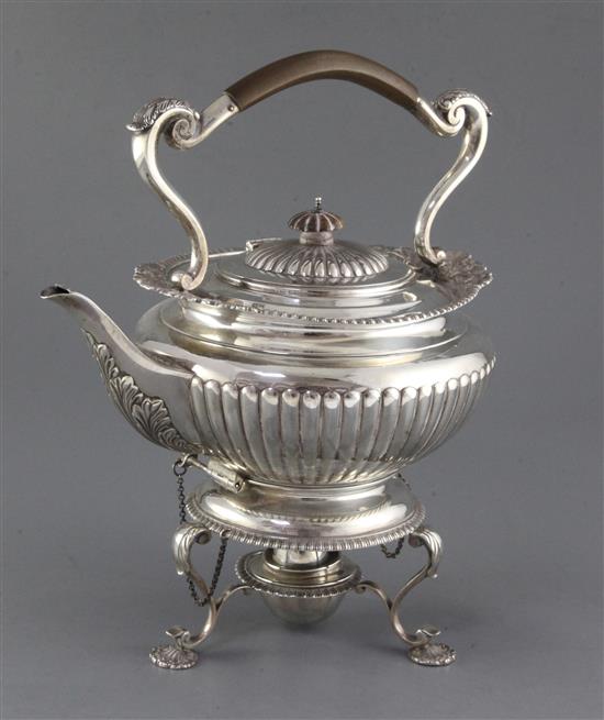 An Edwardian demi-fluted silver tea kettle on stand, with burner, by Edward Barnard & Sons Ltd, gross 58 oz.